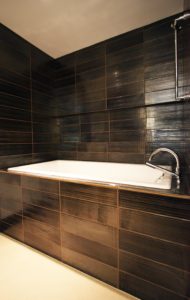 Tub with Black Tile in Pearl Condo Bathroom Remodel