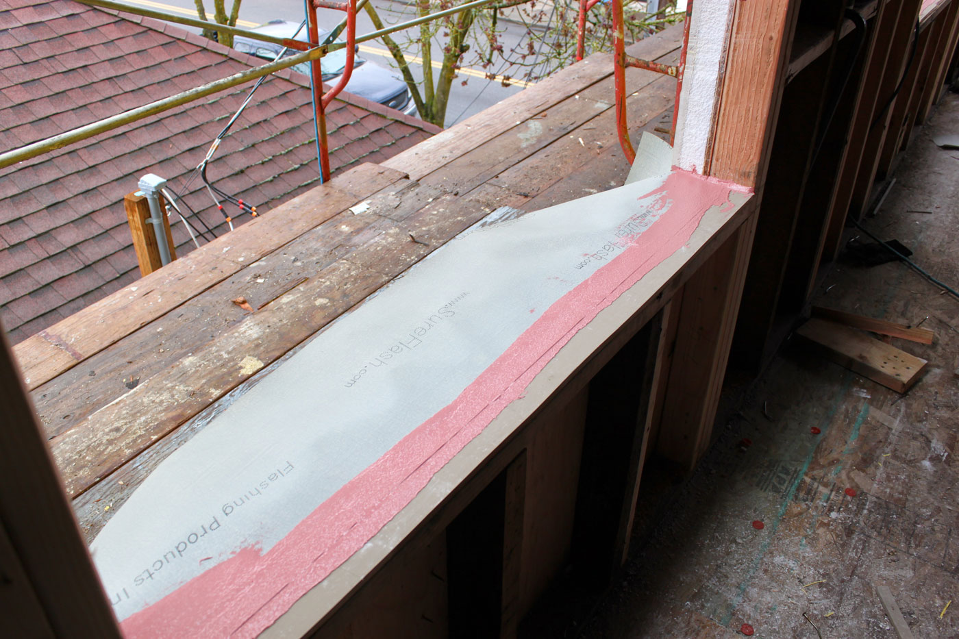 Glasswood passive house window installation: transition membrane going in