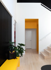 modern entry way and staircase remodel with black yellow and white paint