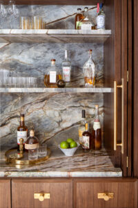 Close up of custom black walnut bar with brass hardware