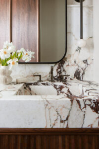 Close up of bathroom sink with waterfalling marble edge